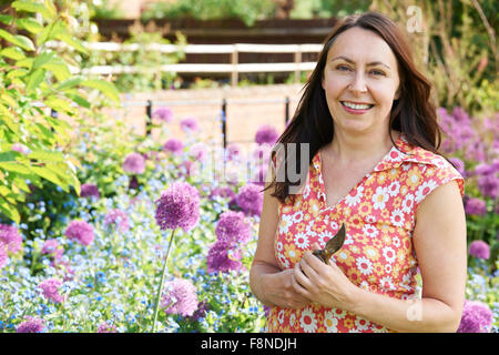Middle Aged Woman Gardening At Home Stock Photo