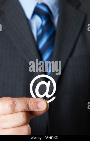 Businessman Holding @ Symbol Stock Photo
