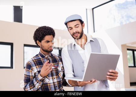 Gay couple using laptop Stock Photo