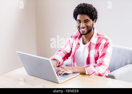 Handsome man using laptop Stock Photo