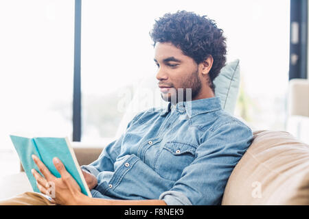 Handsome man reading book Stock Photo