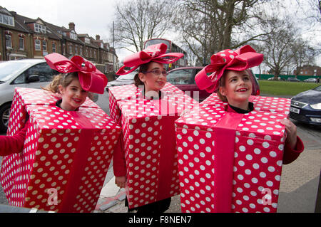 Three cheerful girls in homemade fancy dress costumes for the Jewish holiday of Purim in Stamford Hill, London 5 March 2015. Stock Photo
