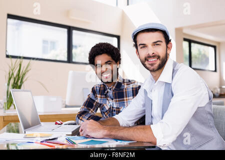 Portrait of smiling gay couple using laptop Stock Photo