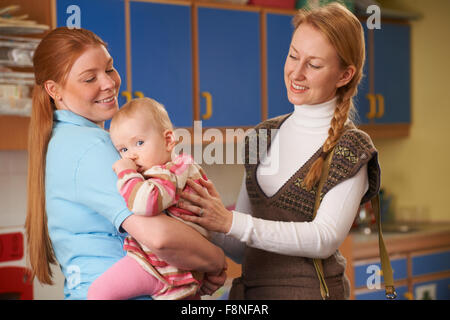 Working Mother Dropping Baby At Nursery Stock Photo