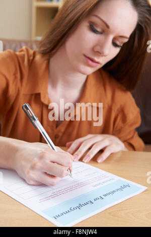Young Woman Completing Employment Application Form Stock Photo