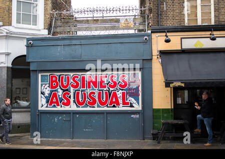 Business as usual sign shop in red letters on Brick Lane in London, UK Stock Photo