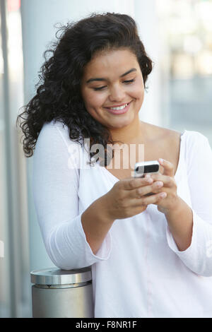 Young Woman Sending Text Message Stock Photo