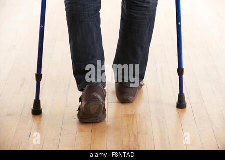Close Up Of Man Using Crutches Stock Photo