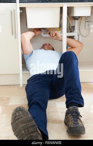 Portrait Of Plumber Fixing Sink Stock Photo