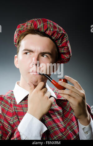 Funny scotsman smoking pipe tobacco Stock Photo