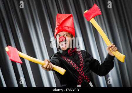 Funny clown with red axe Stock Photo