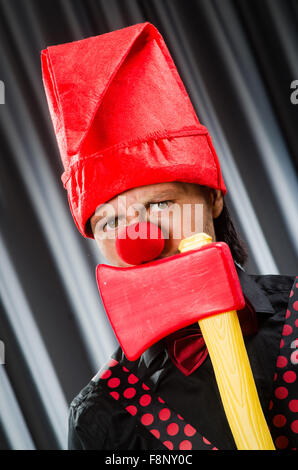 Funny clown with red axe Stock Photo