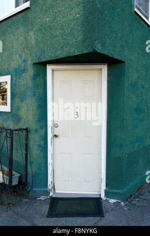 Apartment number three 3 on a white door Stock Photo