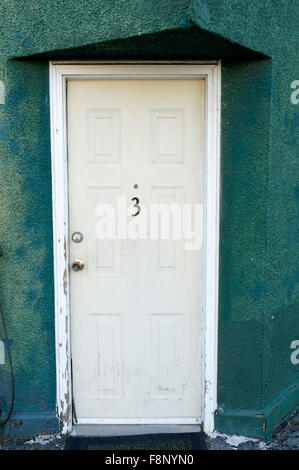 Apartment  number three 3 on a white door Stock Photo