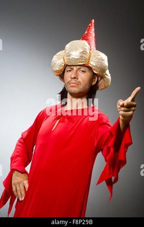 Funny wizard wearing red dress Stock Photo - Alamy