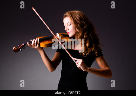 Female musical player against dark background Stock Photo