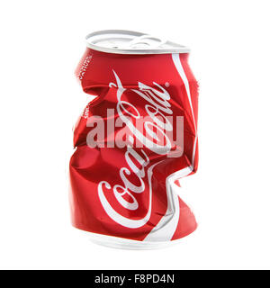 An Empty Dented and Crushed Can of Coca-Cola on a white background Stock Photo