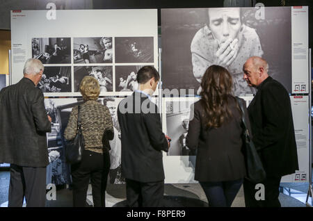 Los Angeles, California, USA. 18th Mar, 2013. Visitors watch the 58th World Press Photo Exhibition during an opening reception at the Rotunda in Los Angeles, the United States, on December 9, 2015. The exhibition will open to public from December 10, 2015 to January 3, 2016. © Ringo Chiu/ZUMA Wire/Alamy Live News Stock Photo