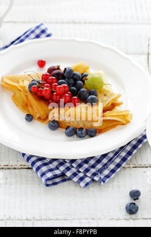 crepes with berries mix on white plate Stock Photo