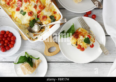 tasty lasagna with spinach on table Stock Photo
