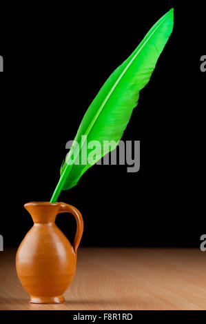 Writing feather against gradient background Stock Photo