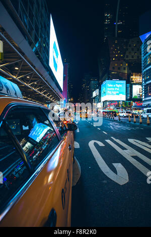 New York City - September 15: Manhattan night view traffic Yellow Cab reflecting advertisements  8th ave, 15 September 2015. Stock Photo
