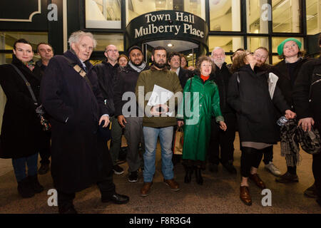 London, UK. 10th Dec 2015. Protesters from the 'More Light, More Power' campaign, who all oppose a proposed £800 million high-rise Bishopsgate Goods Yard development scheme meeting outside Tower Hamlets Town Hall in Mulberry Place before lobbying the council planning meeting. Protesters are lobbying both Hackney and Tower Hamlets council meetings this evening, who would need to approve the scheme if it is to go ahead. The 10 acre site, which is the largest brownfield space close to the City of London would see the construction of almost 1,500 homes in seven towers of up to 46 storeys. © London Stock Photo