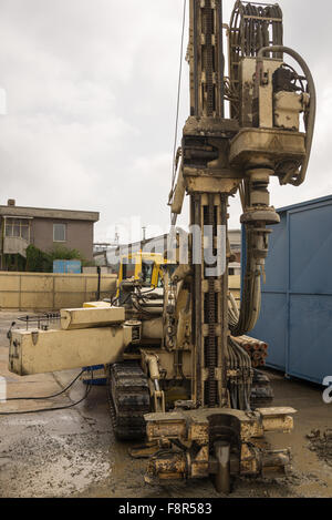 Drilling equipment for geotechnical engineering, environmental protection or soil testing purpose, placed in industrial site. Stock Photo