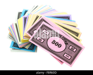 Pile Of Monopoly Money on a White Background,  The classic trading game from Parker Brothers Stock Photo