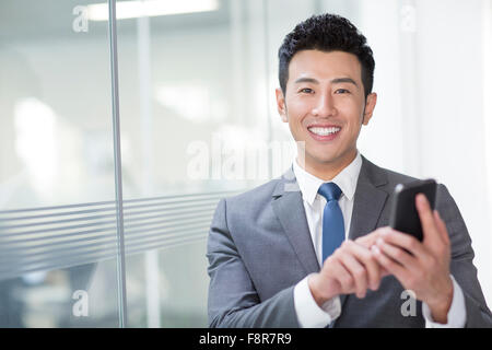 Young businessman using smart phone Stock Photo