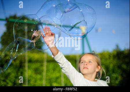 girl playing with soap bubbles in a beautiful garden Stock Photo - Alamy