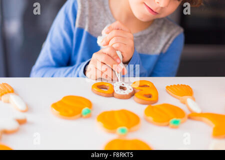 Boy icing cakes Stock Photo