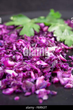 Finely chopped red cabbage with parsley leaves Stock Photo