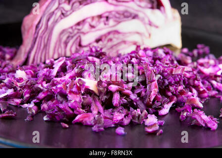 Finely chopped red cabbage with part of the head on the background Stock Photo