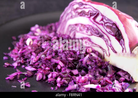 Finely chopped red cabbage with part of the head on the background Stock Photo