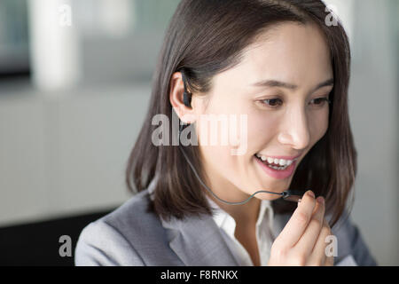 Young businesswoman with headset Stock Photo