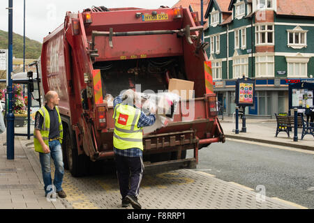 BIFFA commercial waste rubbish collection lorry truck being loaded with trash, UK Stock Photo