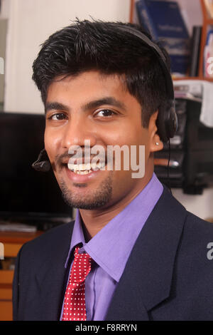 Smiling young call center executive Stock Photo