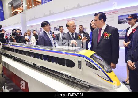 Kuala Lumpur, Malaysia. 11th Dec, 2015. Malaysian Transport Minister Liow Tiong Lai (1st R, front) talks with He Huawu (C, front), chief engineer of China Railway Corporation, at the China High Speed Railway Exhibition in Kuala Lumpur, Malaysia, Dec. 11, 2015. The China High Speed Railway Exhibition, organized by China Railway Group, kicked off here on Friday to demonstrate the development and accomplishment of China's high speed railway. Credit:  Chong Voon Chung/Xinhua/Alamy Live News Stock Photo