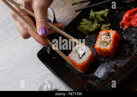 Sushi. Hand with chopsticks Stock Photo