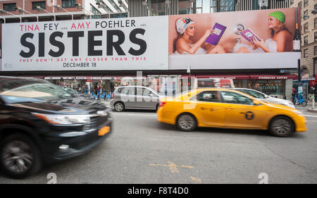 A billboard of the Tina Fey, Amy Poehler film 'Sisters' in New York on Thursday, December 10, 2015. The studios of both 'Sisters and 'Alvin and the Chipmunks: The Road Chip' have decided to open their films on December 18, the same day as 'Star Wars: The Force Awakens' opens. Both movies appeal to different demographics with 'Alvin' going for kids on break and 'Sisters' appealing to the girls-night-out crowd. (© Richard B. Levine) Stock Photo