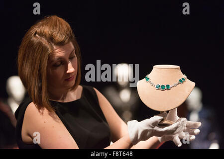 London, UK. 11 December 2015. A Christie's employee presents an Art Deco emerald and diamond necklace by Chaumet, circa 1930, est GBP 120,000-180,000. Mrs Thatcher: Property from the Collection of The Right Honourable The Baroness Thatcher of Kesteven, LG, OM, FRS, the former British Prime Minister Margaret Thatcher will be auctioned at Christie's inLondon. 419 historic and personal lots will be offered in across two landmark sales on 15 December and 16 December (online sale). Stock Photo