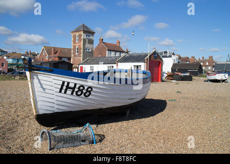 A white fishing boat in front of the old RNLI Lifeboat station at Aldeburgh Suffolk England. Stock Photo