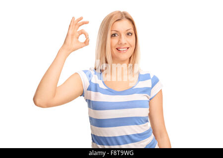 Joyful young woman making OK sign with her hand and looking at the camera isolated on white background Stock Photo