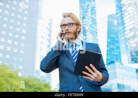 Businessman using a digital tablet in financial district Stock Photo