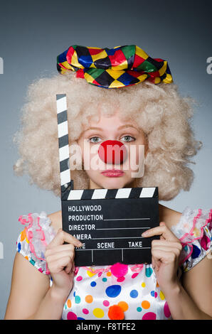 Clown with movie clapper board Stock Photo