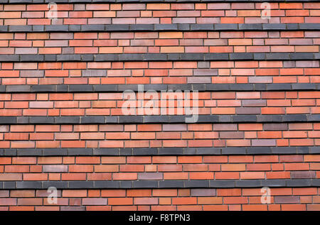 Red brickwall with black stripes Stock Photo