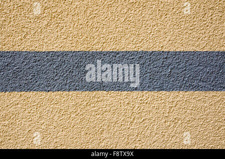 A yellow plaster wall with a grey stripe Stock Photo