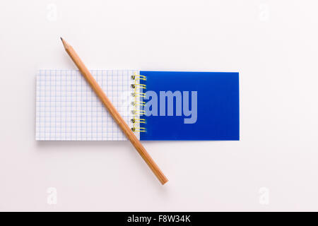 notepad on a white background with a sharp pencil Stock Photo
