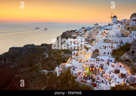 View of Oia Town and windmills at sunset time, Oia, Santorini Island, Greece Stock Photo